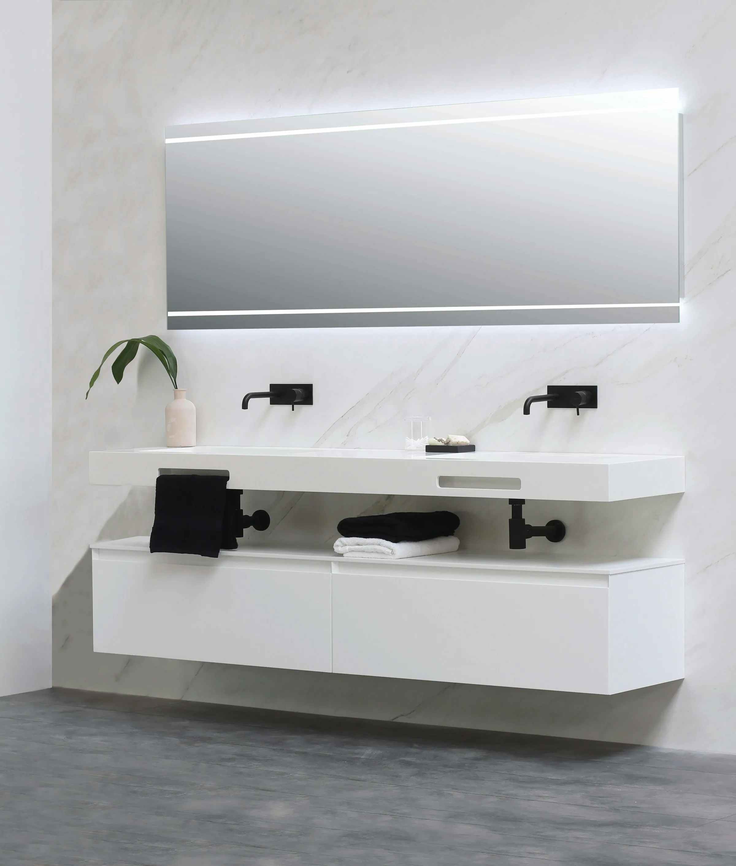 Floating white double vanity with two basins, black taps, and a backlit mirror